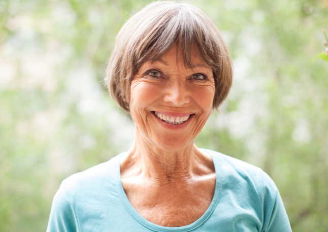 Happy old woman with a natural background