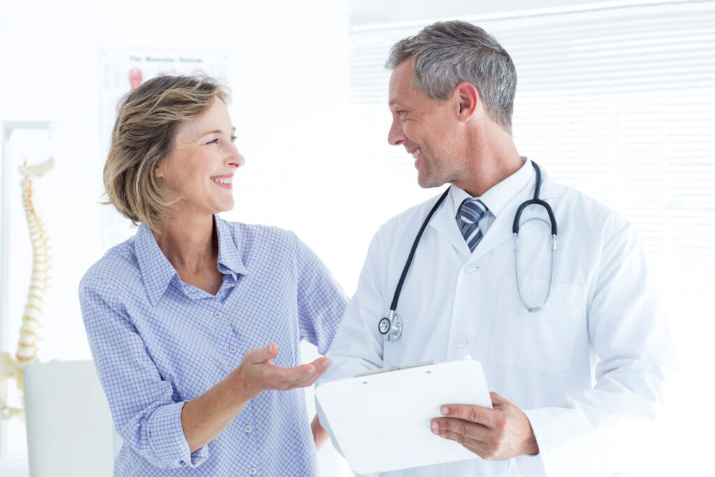 Doctor showing his notes to patient
